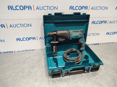 a blue tool box with a drill in it sitting on a table