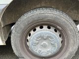 a white truck with a flat tire on the street