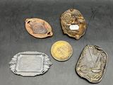 several different metal objects are sitting on a black surface
