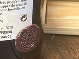 a bottle of wine sitting on a table next to a window