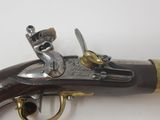 a close up of a gun on a white surface