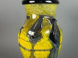 a yellow and black vase with a horse on it
