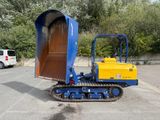 a blue and yellow bulldozer parked in a parking lot