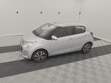 a picture of a small white car parked in a garage