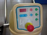 a machine that is sitting in a kitchen next to a sink