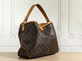 a louis vuitton handbag sitting on a wooden floor