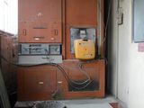 a room that has a lot of appliances and a trash can in it