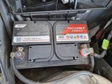 two batteries in the back of a car