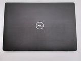 the dell laptop is sitting on a table with its lid open