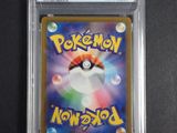 a close up of a pokemon card in a plastic case