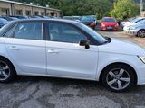 a picture of a white car parked in a parking lot