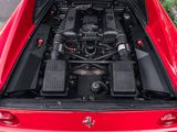 the engine compartment of a red sports car with its hood open