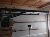 a picture of a garage with a rack of skateboards hanging from the ceiling