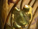 a close up of a vase with a gold decoration