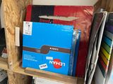 a blue box sitting on a wooden shelf next to a stack of books