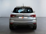 the rear end of a silver car in a white room