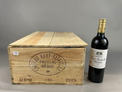 an old wooden box with a bottle of wine next to it