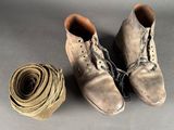 two pairs of shoes and a roll of rope on a gray surface