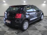 a picture of a black vw volkswagen polo parked in a garage