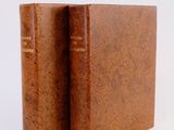 an old book sitting on top of a table next to a white background