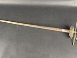 a close up of a sword on a black surface