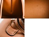 the inside of a tan purse with a zipper on the inside