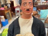 a figurine of a man holding a heart in his hands