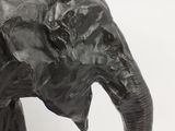 sculpture of an elephant with tusks on a white background