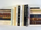 a lot of books that are stacked on top of each other