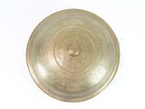 a gold plate on a white surface with a white background