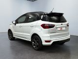 the rear end of a white ford eco - pace parked in a garage
