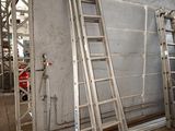 two ladders leaning against a wall in a building
