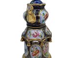 a close up of a vase with a bird on top of it