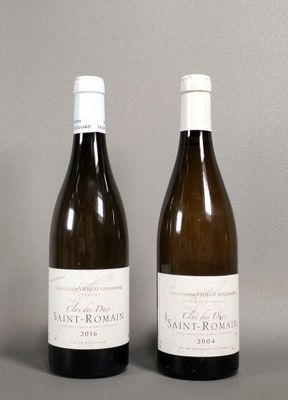 two bottles of wine sitting next to each other on a table