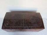a wooden box with a design on it on a white surface