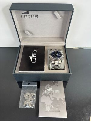 lotus watch in a box with a card and a watch in it