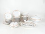 a lot of plates and bowls that are sitting on a table