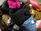a box full of clothes that is sitting on the floor