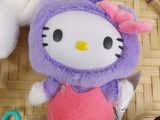 a hello kitty stuffed animal sitting next to a pair of scissors