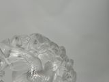 a clear glass vase with flowers in it on a table
