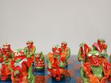 a lot of figurines that are sitting on a chess board