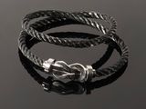 a close up of a bracelet with a knot on a black surface