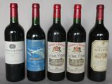 several bottles of wine are lined up on a table