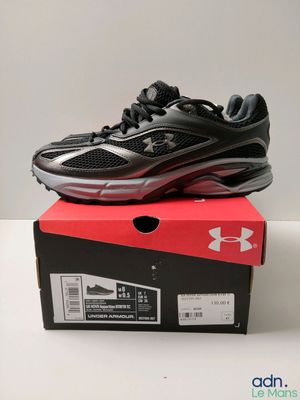 a pair of black and red shoes on top of a box