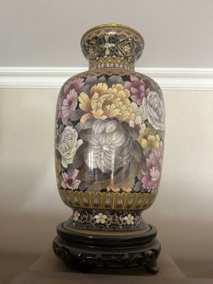 a vase that is sitting on a table with flowers on it
