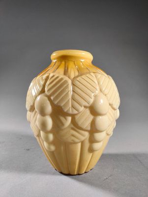 a yellow vase that is sitting on a table