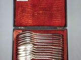 silverware in a case on a table with a red cloth