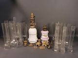 a lot of glass vases and a lamp on the table