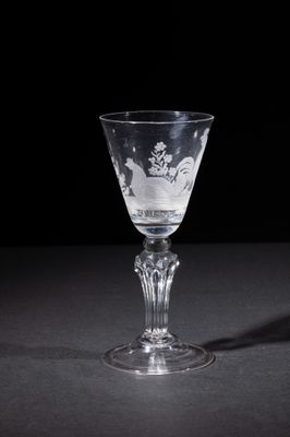 a wine glass that is sitting on a table