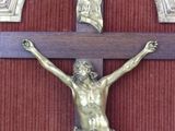 a statue of jesus on the cross on the wall